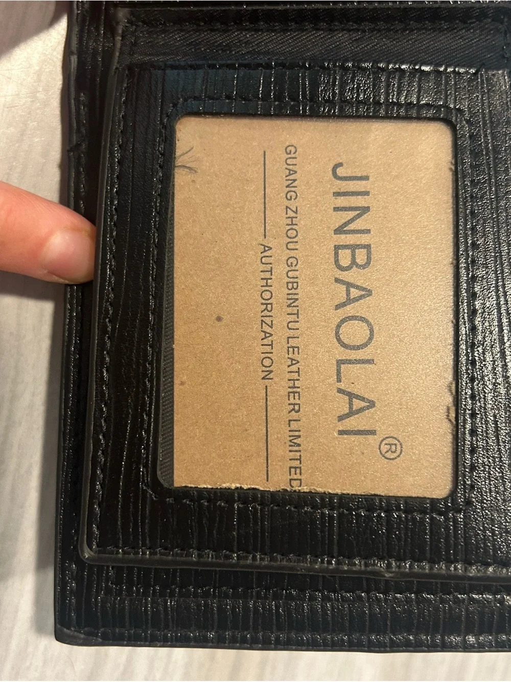 Men's Black Leather Bi-Fold Wallet with Embossed Face and Yellow Eye Accent